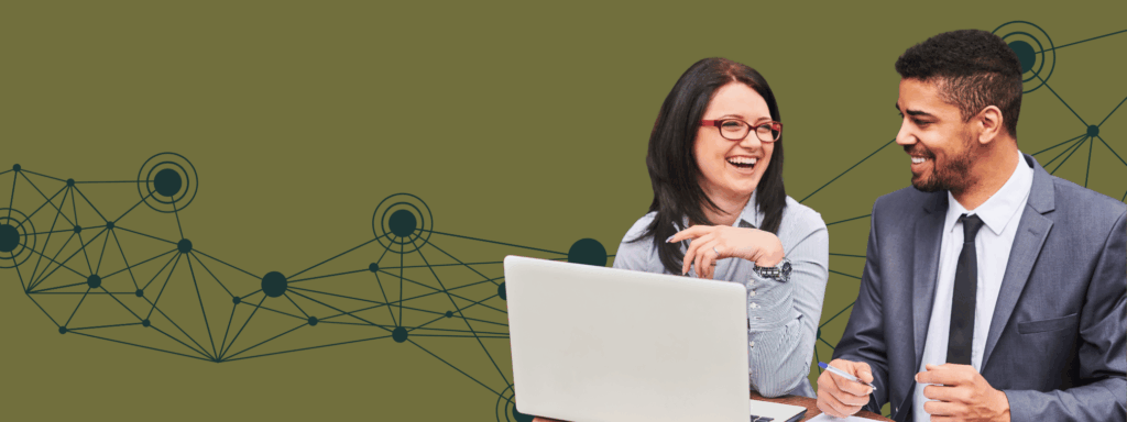 two people at a computer having a good laugh